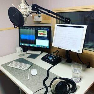 the voiceover booth at Natalie Cooper's studio features a large monitor, an ipad alongside, and a Neumann TLM mic inbetween