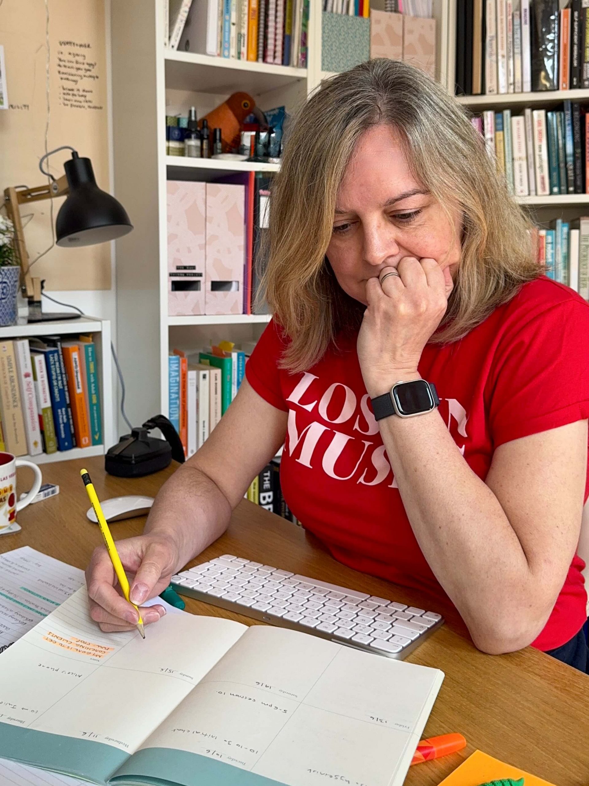Natalie Cooper sits at her desk writing with a pencil