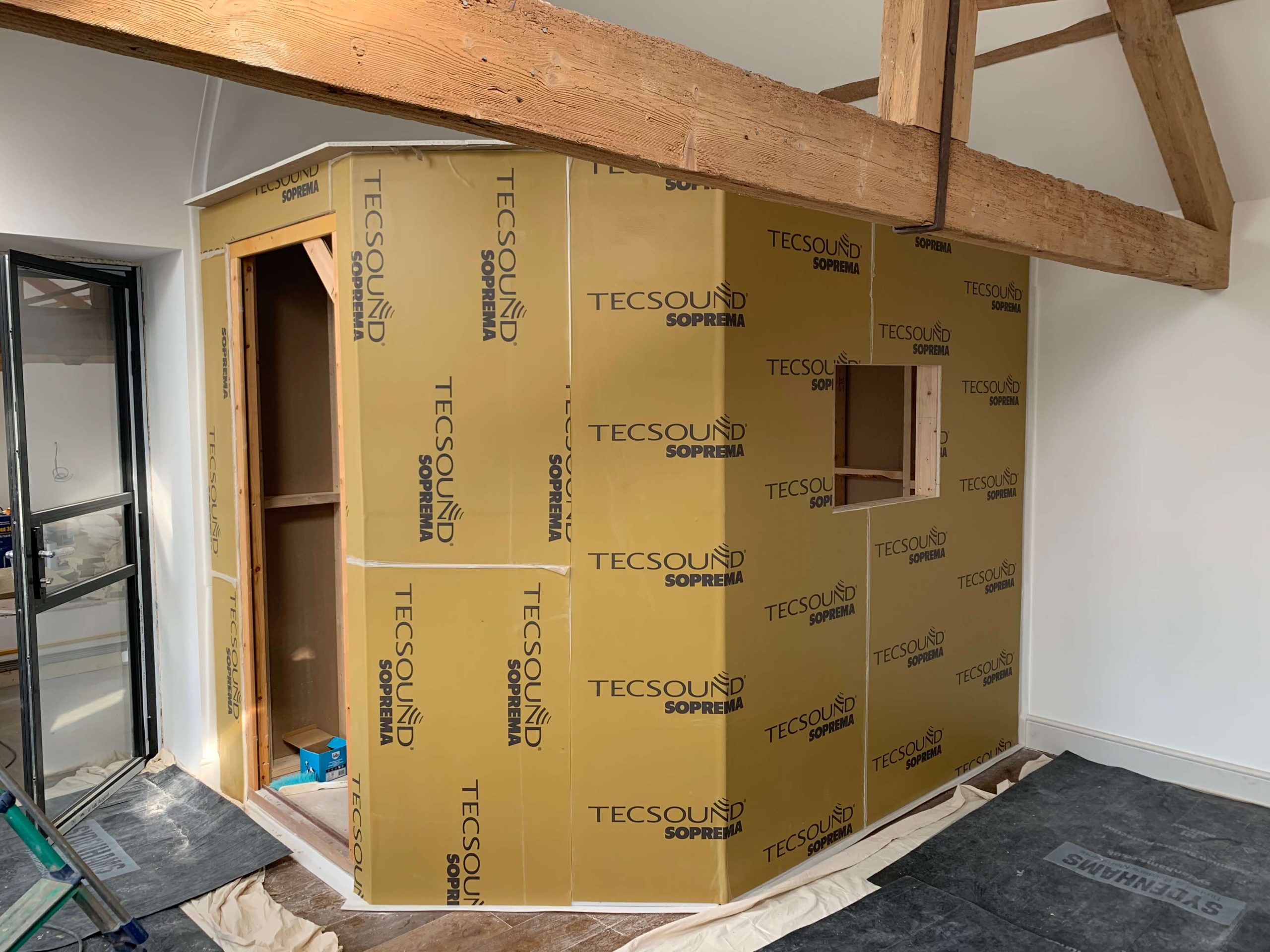 Wooden frame of a home voiceover recording booth covered in TecSound acoustic membrane.